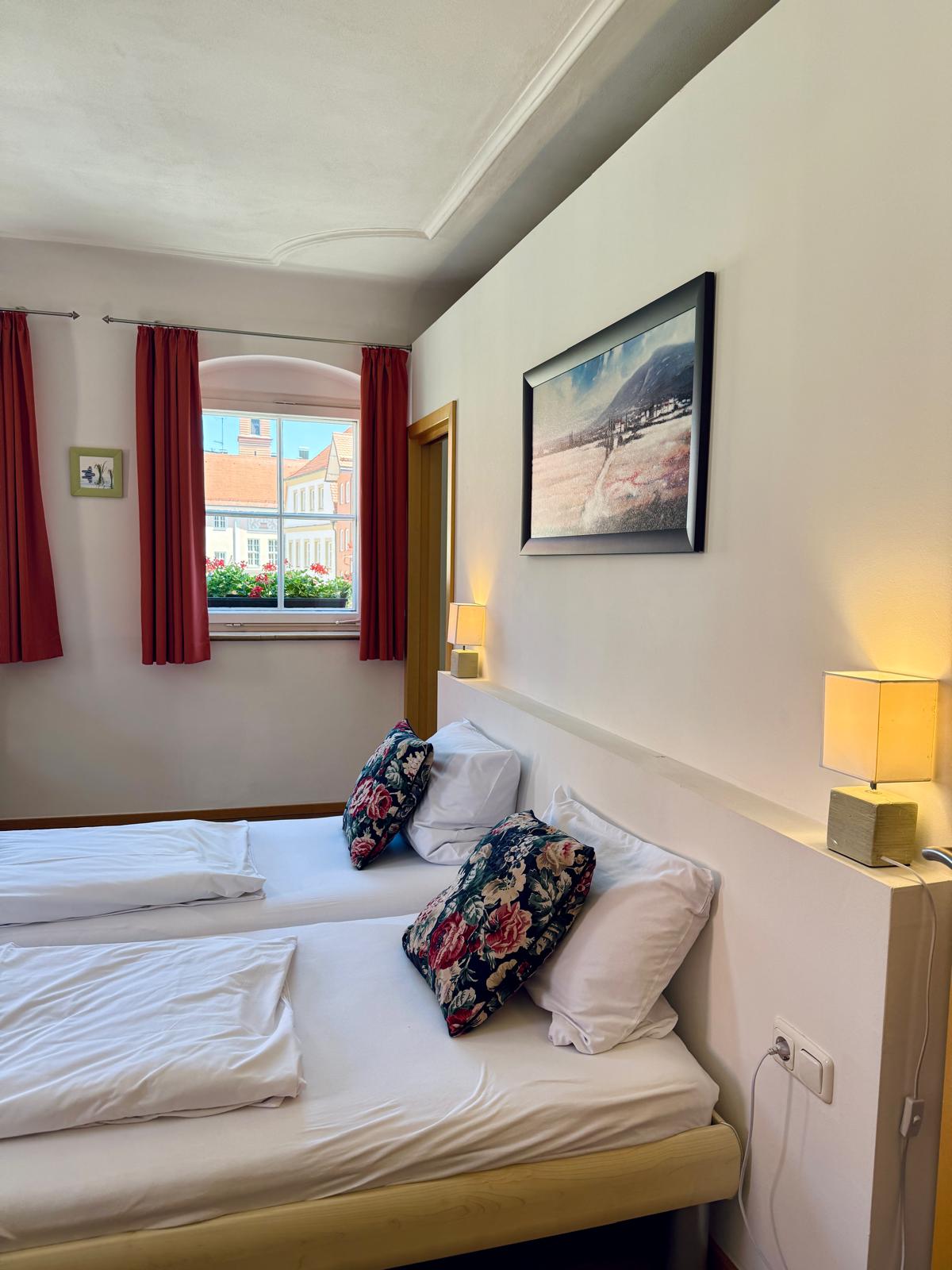 Spacious family suite bedroom with double bed at Hotel Stadtblick Friedberg